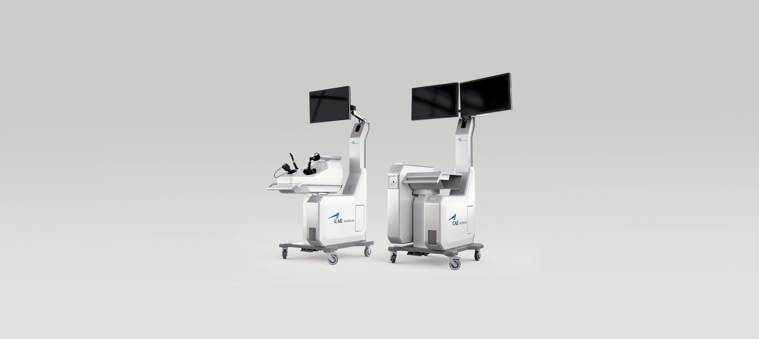 Two modern medical workstations on wheels, each with a large monitor, control panels, and the “Einstein” logo on the front, are showcased against a light gray background by an Agence de développement de produits médicaux au Canada.