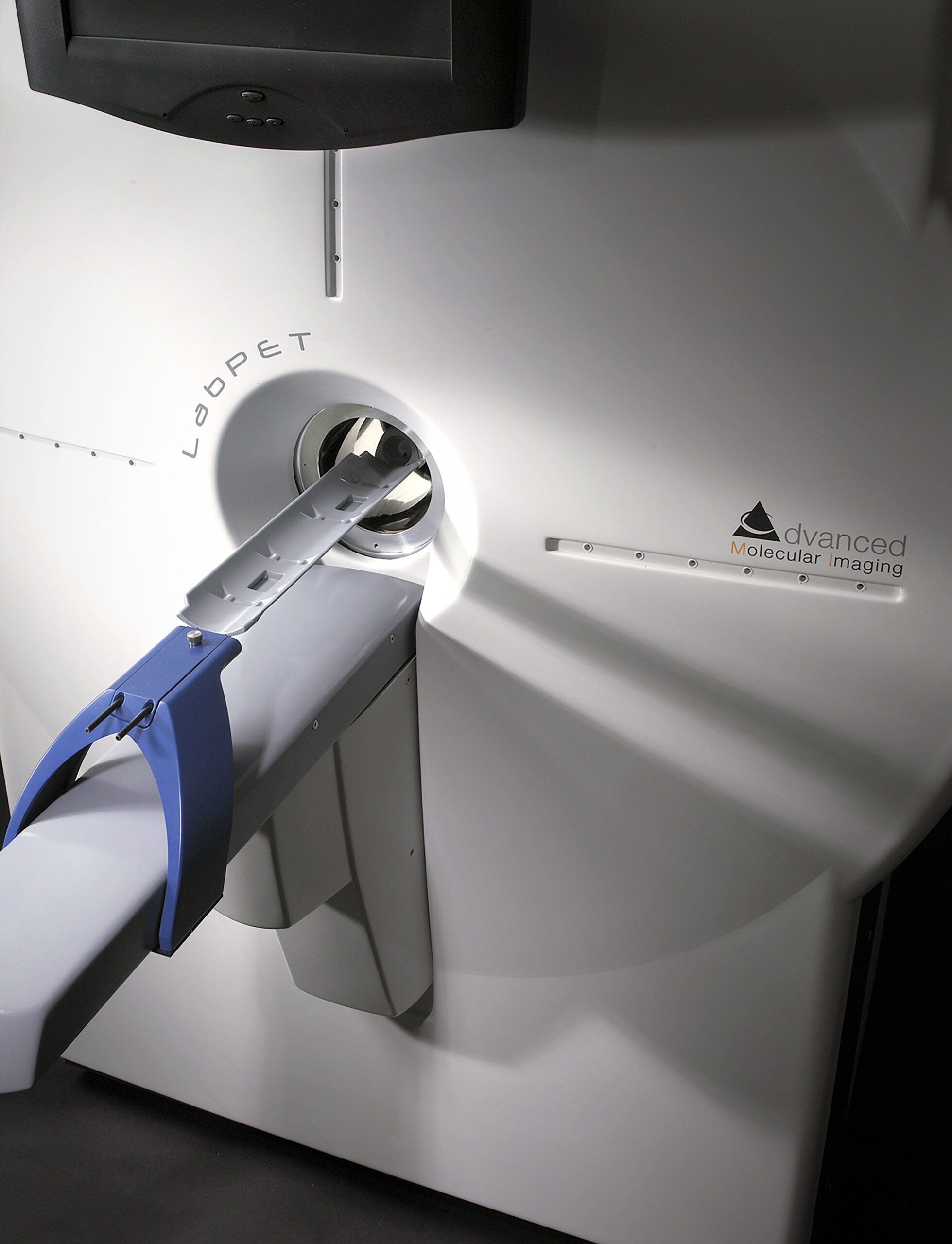 A close-up of a LabPET advanced molecular imaging scanner, featuring a padded restraint on a sliding tray entering the device—innovative equipment shaped by an agence de développement de produits à Montréal.